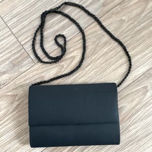 NWOT Black evening clutch or shoulder bag.Beaded strap that can be hidden inside